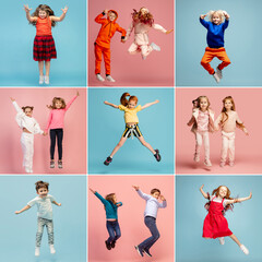 Group of elementary school kids or pupils jumping in colorful casual clothes on blue and pink studio background. Creative collage.