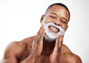 Forming a foamy cushion on the face before shaving. Studio portrait of a handsome young man...