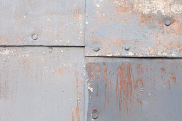 Background surface texture of old rusty metal sheets fastened with nails looks like aged building cladding. High quality photo. Place your text