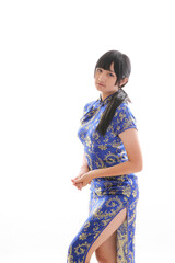 beauty woman wear blue cheongsam looking and smile in chinese new year