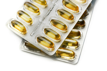 omega3 capsules in blister pack, closeup isolated on white background.