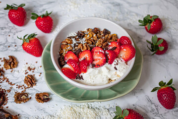 Sirtuin muesli in a white bowl on a marble background