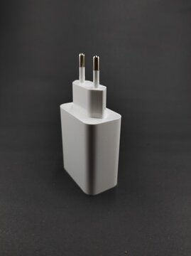 Photo of a white smartphone charger isolated on a black background, Not Focus