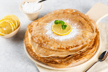 Pancakes with lemon and sugar. Traditional for Shrove Tuesday. Pancake day. Pancakes with lemon juice and powdered sugar. Russian Maslenitsa. Sweet crepes. shrovetide holiday.