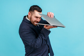 Portrait of curious bearded businessman wearing official style suit carefully peeking into...