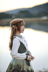 A beautiful woman in lolita dress in garden background Japanese street fashion portrait