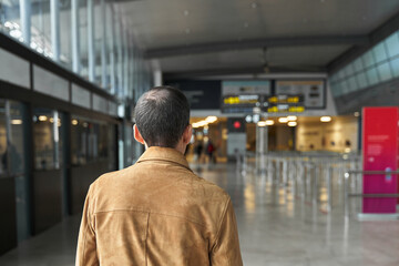 Senior man walking at the airport before flight