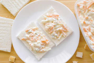 Coleslaw sandwich on a white plate.  Food from above concept.  Flat lay top view food photography.