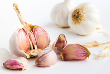 garlic heads and cloves on white background