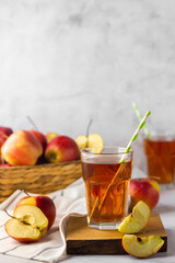 apple juice and red apples in basket