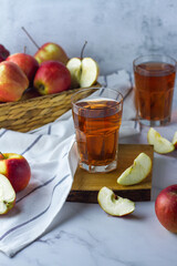 apple juice and red apples in basket