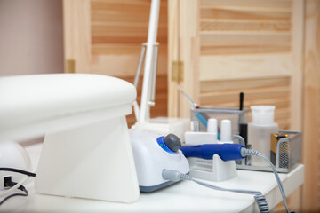 Nail salon table with manicure tools and nail polish bottles