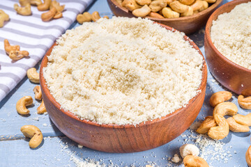 Alternative keto diet gluten grain free flour. Paleo and ketogenic diet baking cooking concept. Cashew flour with whole nuts