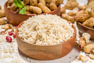 Alternative keto diet gluten grain free flour. Paleo and ketogenic diet baking cooking concept. Peanut flour with whole nuts
