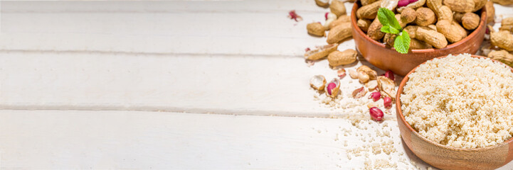 Alternative keto diet gluten grain free flour. Paleo and ketogenic diet baking cooking concept. Peanut flour with whole nuts