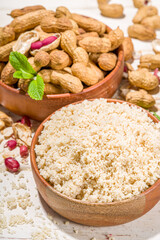 Alternative keto diet gluten grain free flour. Paleo and ketogenic diet baking cooking concept. Peanut flour with whole nuts