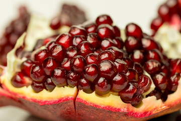 Fresh pomegranate and seeds on white background.