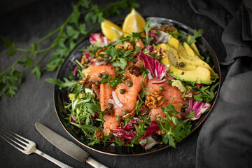 Super Sirtuin salad in a stylish black plate over black background