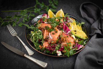 Super Sirtuin salad in a stylish black plate over black background