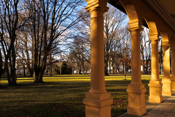 the columns of the walkway in the Hessinpark in Augsburg shine in the golden sunlight