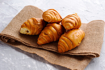 fresh croissants with chocolate filling on burlap