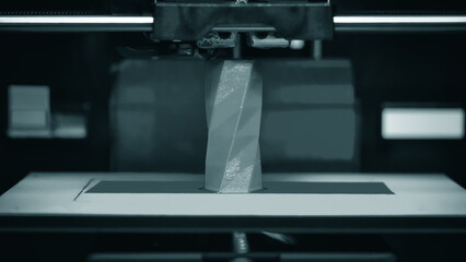 3D printer works and creates an object from the hot molten plastic close-up. Automatic three...