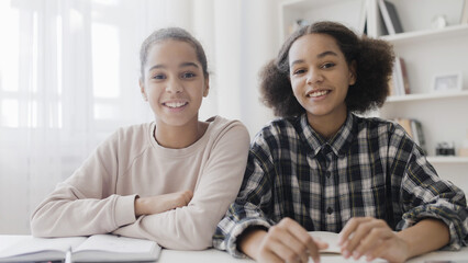 Happy teen sisters talking to grandparents online, family connection, technology