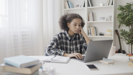 Upset teenage girl reading bad news email on laptop, failing at school test