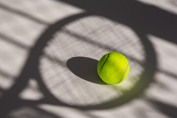 Tennis ball and its shadow on an isolated white background. Tennis ball has tennis racket and net...