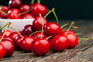 red ripe sweet cherries on a wooden table