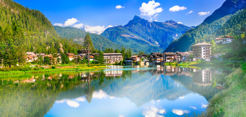 Amazing alpine scenery, Dolomites mountains. Beautiful lake lago di Alleghe and scenic village....