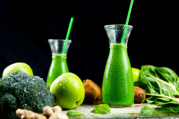 Healthy green smoothies with spinach, apple, kiwi, broccoli and mint in glass jar with fruits and vegetables on the wooden table. Detox and healthy concept