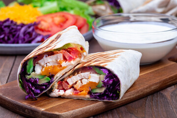 Grilled chicken wraps with red cabbage, avocado, tomato, lettuce, cheddar cheese, horizontal