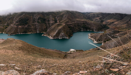 Panoramic view. Mountain lake with turquoise water on a cloudy day. Elbrus region