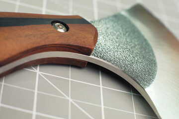 Special halberd cutting knife leather piece in workshop. Craft tanner tool production. Close up...