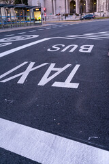 Obraz premium Horizontal taxi and bus signage on a paved street