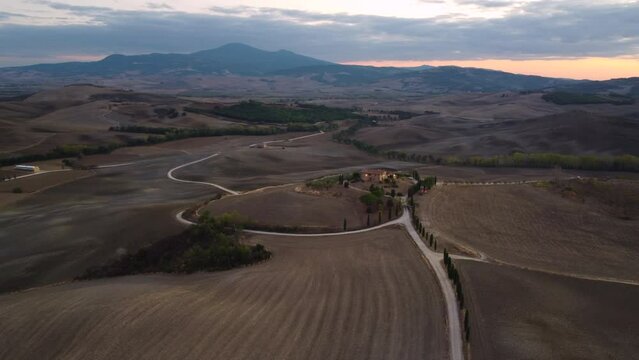 Famous Gladiator cypress road and farmhouse in Val d'Orcia, Pienza Tuscany aerial view, Italy