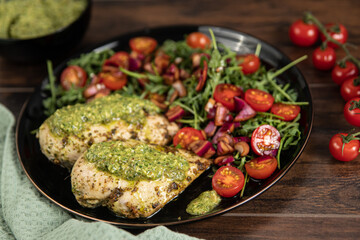 Chicken breast baked in nut and parsley pesto with red onion salad