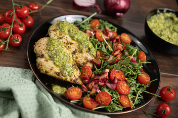Chicken breast baked in nut and parsley pesto with red onion salad
