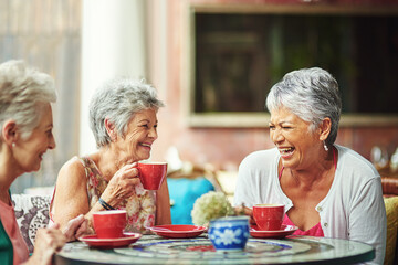Lifelong friends catching up over coffee. Cropped shot of a group of senior female friends enjoying...