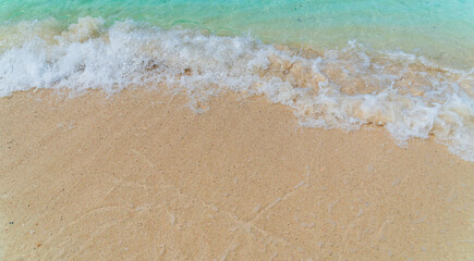 Fototapeta na wymiar sand beach with foamy sea waves