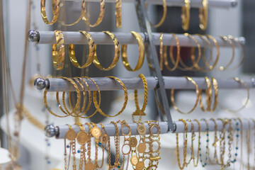 Jewelry shop window with a huge selection of gold jewelry bracelets, chains, rings
