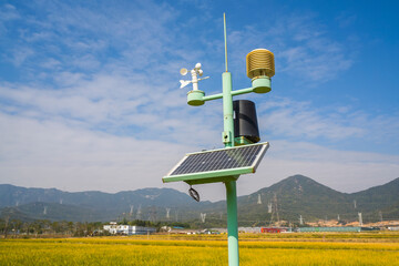 weather station with solar panel placed in the field to monitor atmospheric conditions.