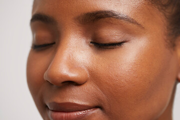 Close-up of smiling woman with eyes closed