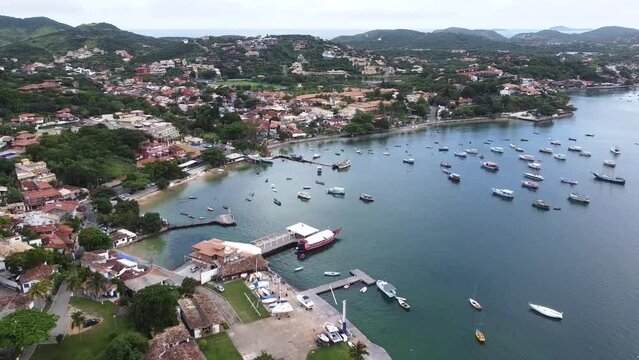 Top view of Ossos beach with beautiful green water and boats on the shore, Arma&ccedil;&atilde;o de B&uacute;zios, Rio de Janeiro - drone view