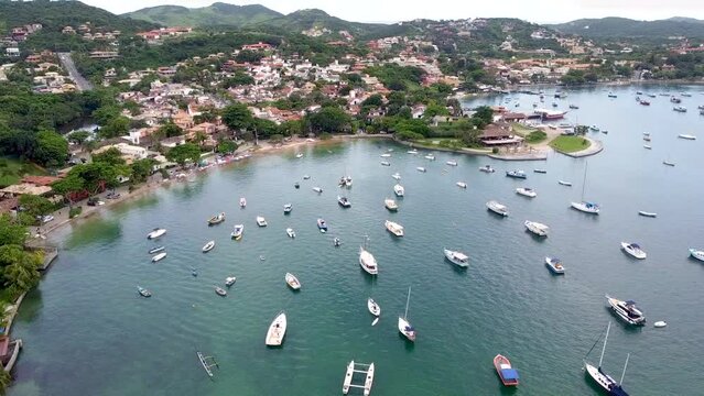 Top view of Ossos beach with beautiful green water and boats on the shore, Arma&ccedil;&atilde;o de B&uacute;zios, Rio de Janeiro - drone view
