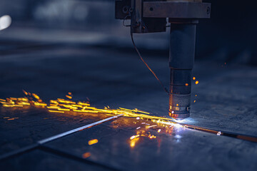 Fiber laser cutting CNC machine cuts metal list. Making metal part. Workshop in factory