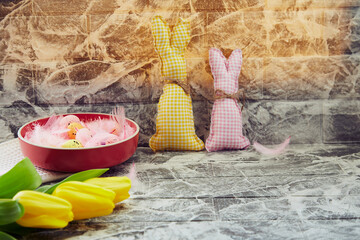 Easter background: carfting soft bunnies, yellow tulips. Copy space. Creative colorful spring. Easter background.