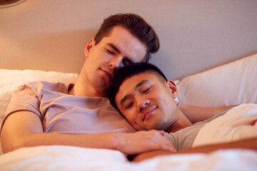 Loving Same Sex Male Couple Lying In Bed At Home Asleep