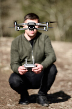 Drone pilot, controlling the flight of a quadcopter with a manual control panel.